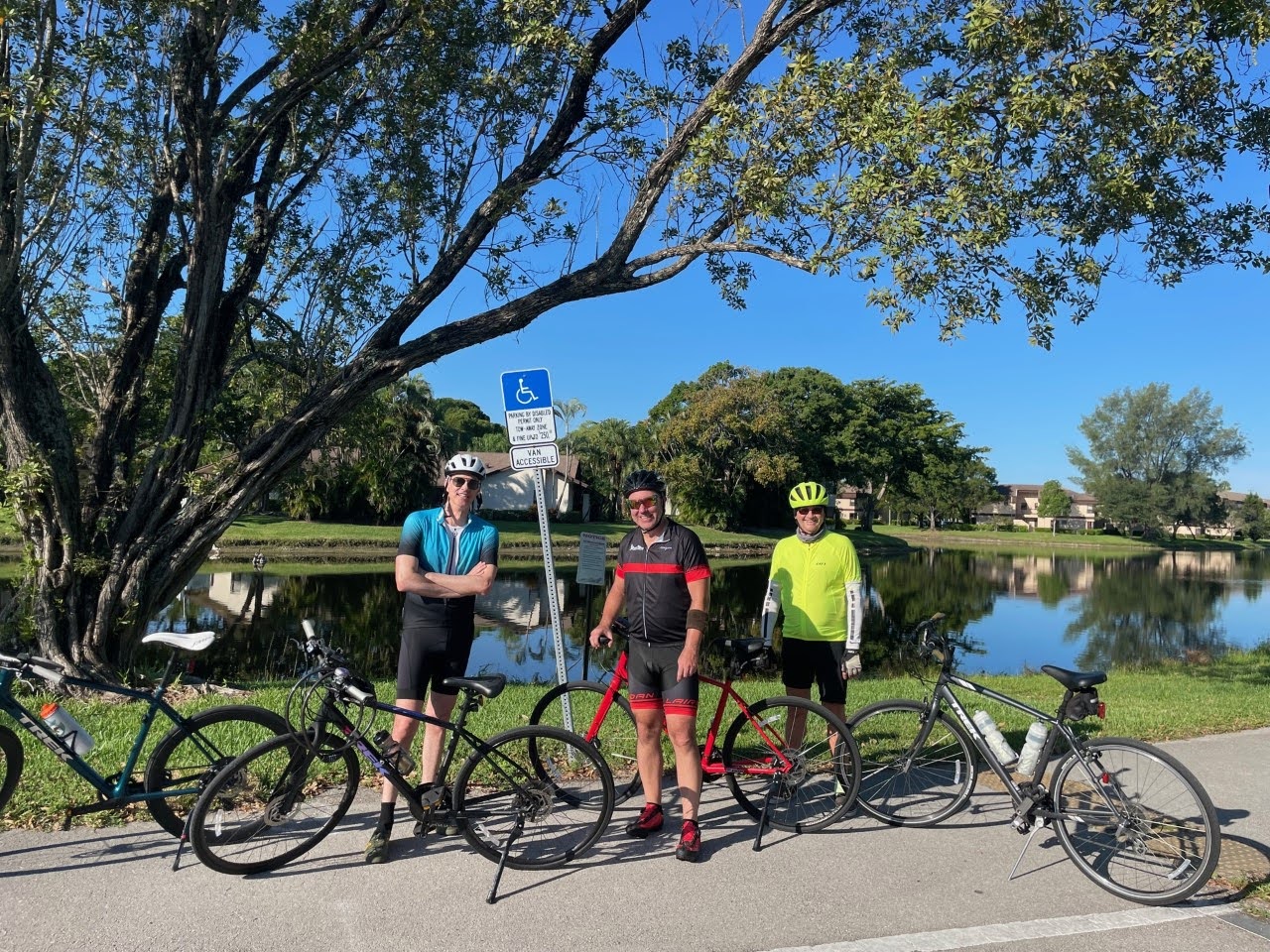 3 people pose with their Trek hybrid and road bikes next to a waterway in Florida.o 3 people pose with their Trek hybrid and road bikes next to a waterway in Florida.o